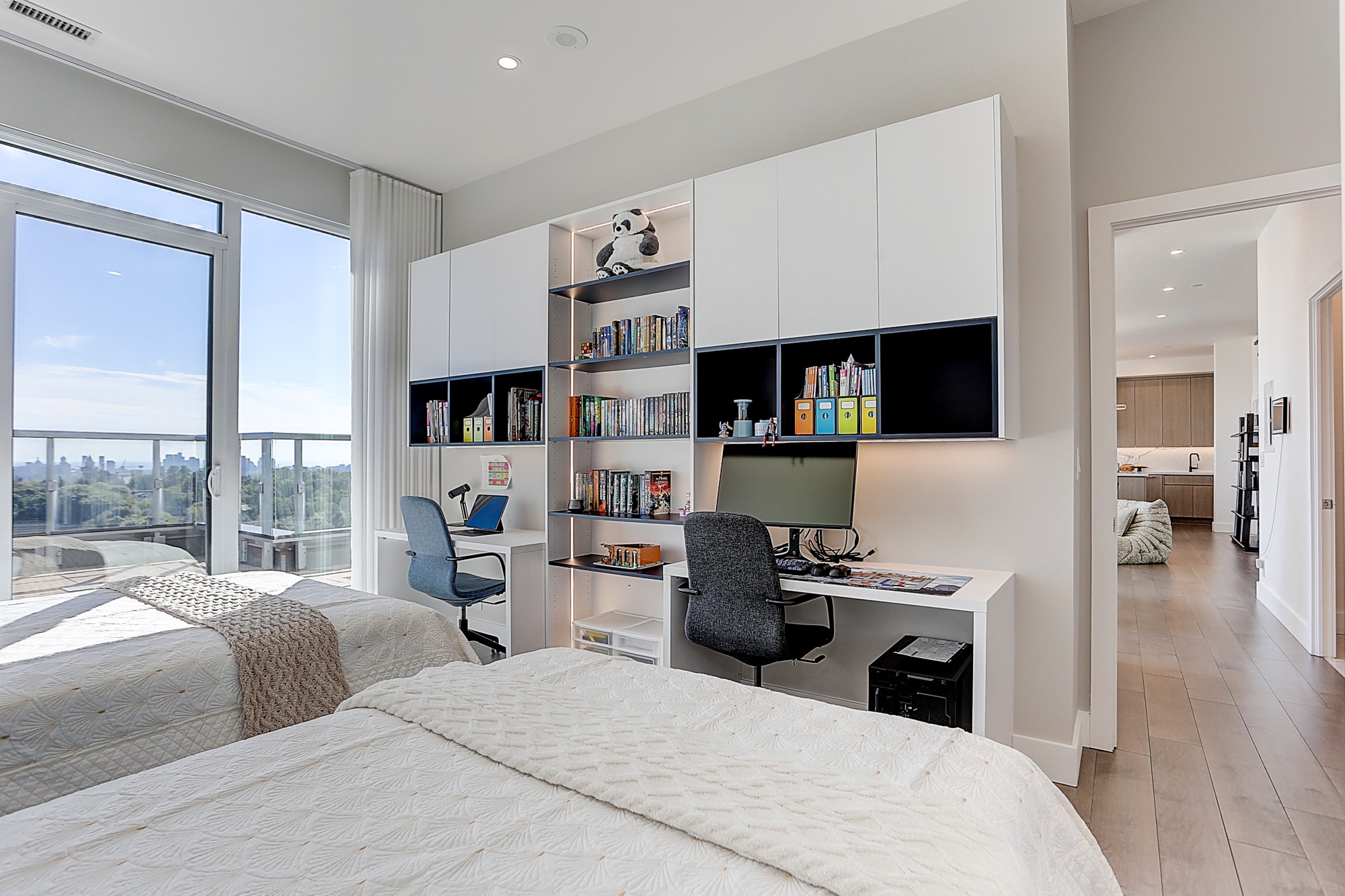 Built-in desk with white upper cabinets and open shelves in a Toronto condo